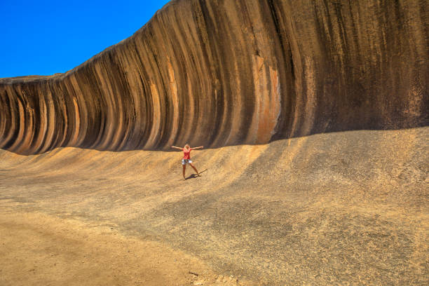 istock Woman at Wave Rock Australia 1090280480