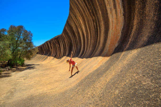 istock Wave Rock woman surfing 1090280484