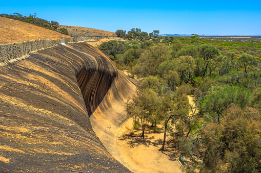 Aerial view from top of popular place of Wave Rock, in Australian outback, near Hyden, Western Australia. The natural rock formation is shaped like a tall ocean wave in Hyden Wildlife Park. Copy space
