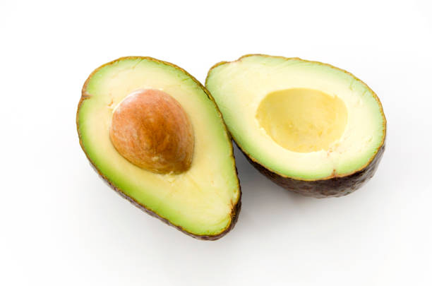 istock Ripe organic avocados half with seed on white background. 1090285794