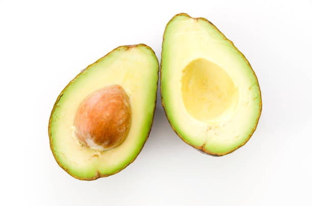 istock Ripe organic avocados half with seed on white background. 1090286862