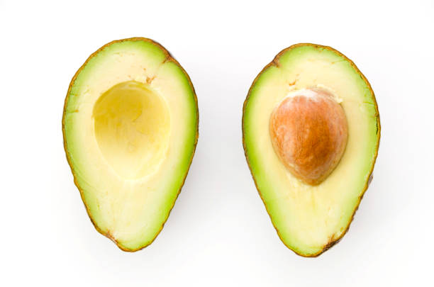 istock Ripe organic avocados half with seed on white background. 1090286896