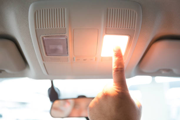 istock Men's hand pressing the car's ceiling light 1090298170
