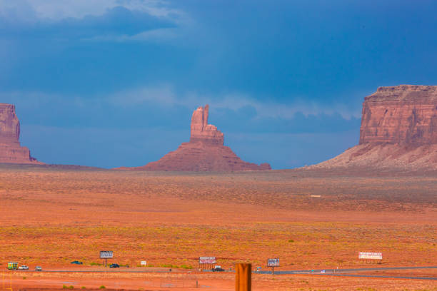 Monument Valley, a red-sand desert region on the Arizona-Utah border, is known for the towering sandstone buttes of Monument Valley Navajo Tribal Park. Monument valley landscape with buttes.