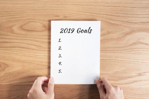 istock Hands man present 2019 goals list on paper, Top view, copy space. 1090309650