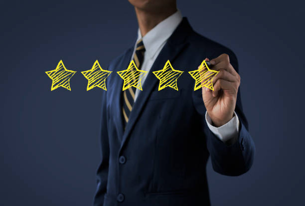 istock Increase rating, ranking, review, evaluation or classification concept. Businessman is drawing five yellow stars to increase rating of his business on dark tone background. 1090313866