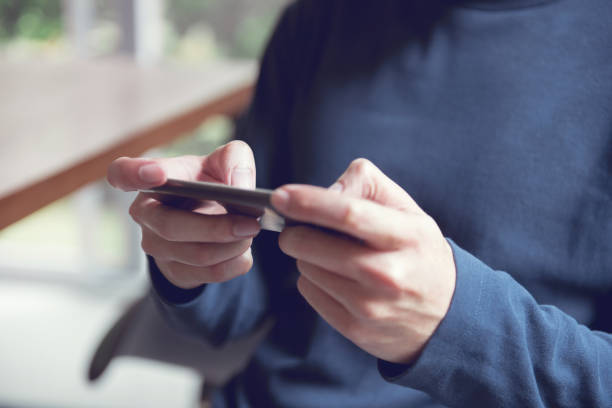 istock Close up of man hands playing a game on a mobile smartphone during leisure time. 1090315292