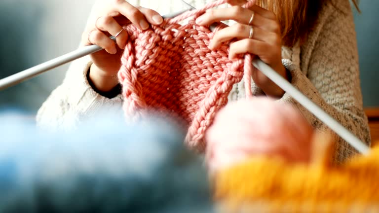 Close up on woman's hands knitting