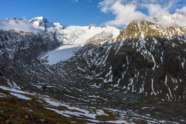 View to the mountain Dreiherrnspitze (3,499 m, left) and the Umbal glacier (German: Umbalkees) at sunset. This mountain range belongs to the Venediger Group (German: Venedigergruppe). It is located in the European Alps in Austria and part of the main ridge Hohe Tauern.