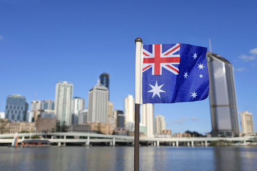 The Australian flag against Brisbane the capital city  of Queensland, Australia.