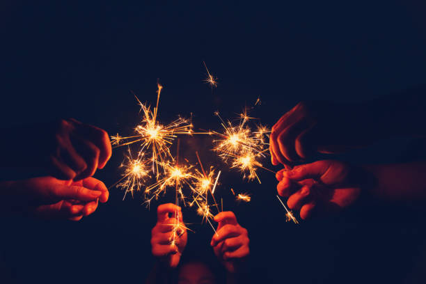 istock Group of people having fun with sparklers. 1090327162