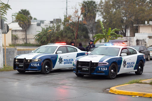 Matamoros, Tamaulipas, Mexico - November 20, 2018: Two Tamaulipas State Police cars, blocking a street in the city of Matamoros with their sirens on.