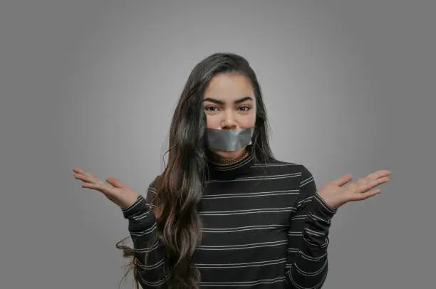 Photo of Woman with mouth taped shut