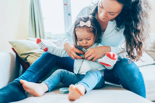 istock Mother dressing her daughter 1090343354