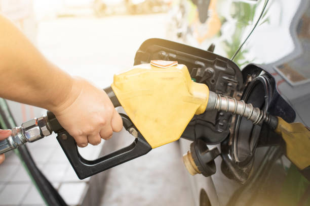 istock Hand holding fuel nozzle to refuel gasoline for car. 1090346382
