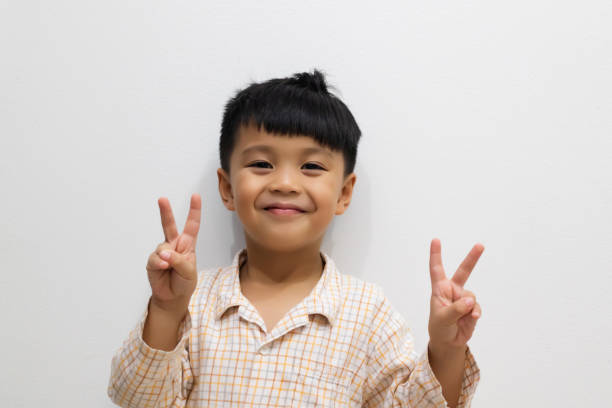 istock Asian cute boy doing the victory symbol 1090346432