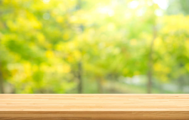 istock Real wood table top texture on leaf tree garden background.For create product display or design key visual 1090350658