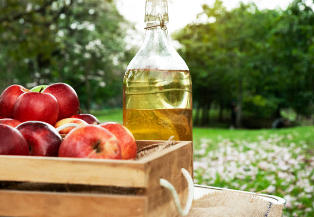 istock Close-up Red apple and apple oil on wood table. 1090350746