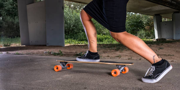 istock young women with Tatoos with a longboard 1090355450