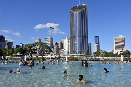 BRISBANE - DEC 25 2018: People swimming in streets beach public swimming pool and parklands in Brisbane city, Queensland, Australia