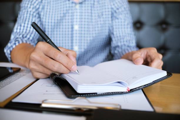 istock Man student writes information from portable tablet while prepare for lectures in University campus. 1090355684