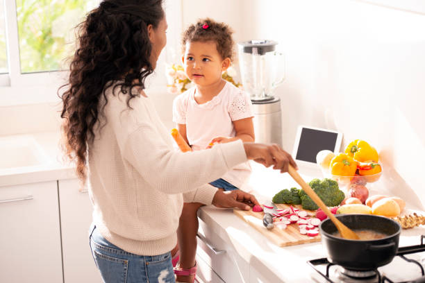 istock Mother and daughter preparing a soup at kitchen. 1090357456