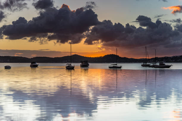 istock Sunrise and Cloud Reflections on the Bay with Boats 1090358110