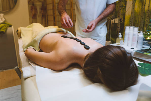 istock Spa treatment - Woman getting a hot stone massage 1090358280