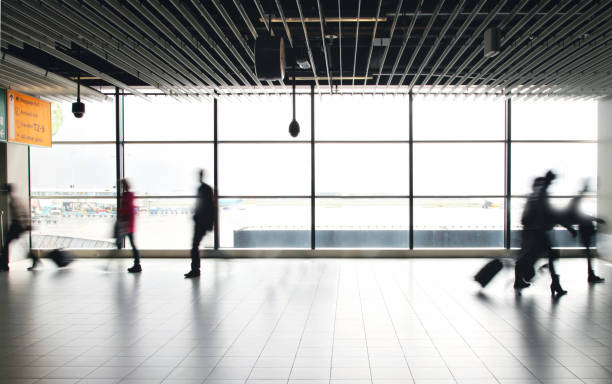 istock Airport passengers crowd walking blurred people 1090362972