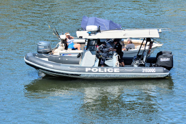GOLD COAST - DEC 18 2018:Australian Police patrol boat checks motor boats on the rivers of Gold Coast, Queensland, Australia