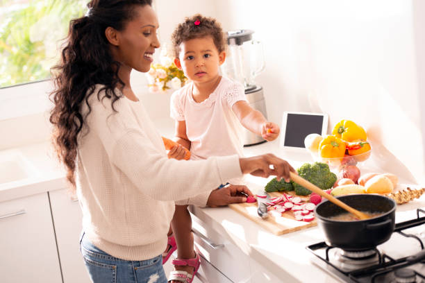 istock Mother and daughter cooking a soup. 1090367668