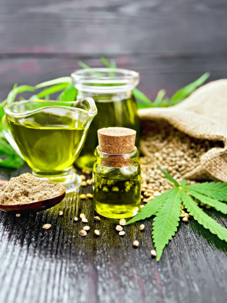 istock Oil hemp in two jars and sauceboat on dark board 1090370082