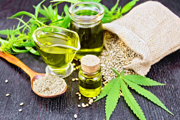 istock Oil hemp in two jars and sauceboat on board 1090370098