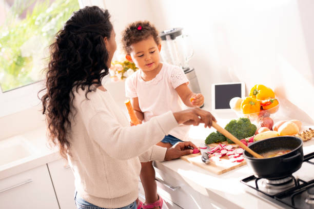 istock Mother and daughter cooking a soup. 1090371276