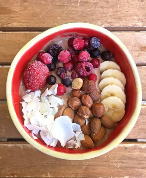 Healthy breakfast, freshly prepared is the Smoothie Bowl. Ingredients are various fruits such as blackberries and banana and yogurt or porridge.
