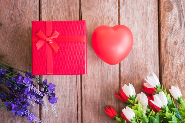 istock Red heart, flower and gift box on wooden background 1090389206