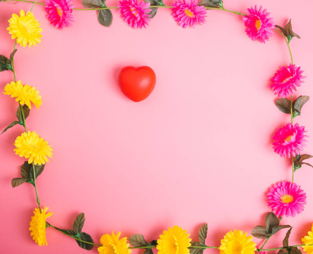 istock Red heart and flower on pink background with copy space 1090389368