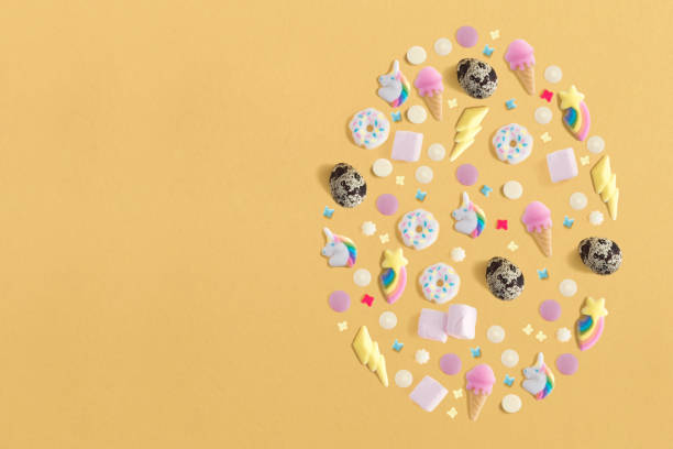 istock Arrangement decoration for Happy Easter, holiday background concept. Colorful eggs, sweets and topping ornament design as big egg on yellow pastel desk with copy space. Flat lay 1090391508