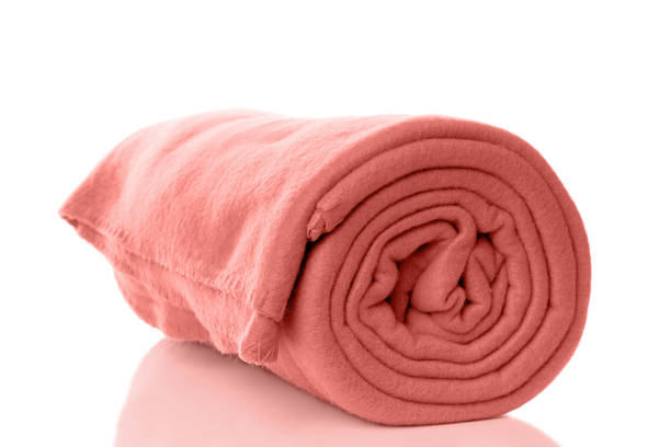 fleece blanket in living coral color of the year 2019 rolled up fleece blanket in living coral - color of the year 2019 fleece photos stock pictures, royalty-free photos & images