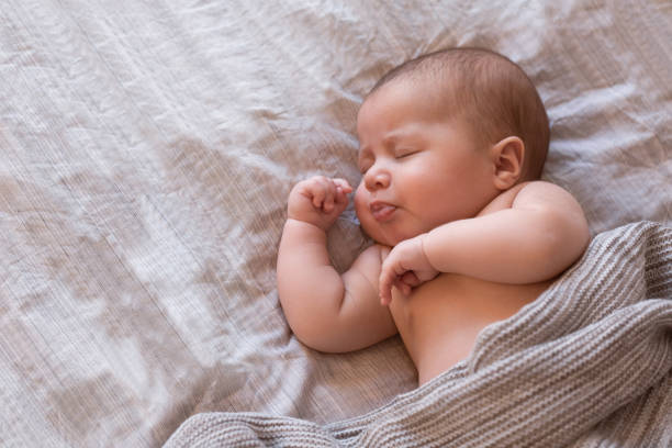 istock Peaceful baby lying on a bed and sleeping at home 1090396274