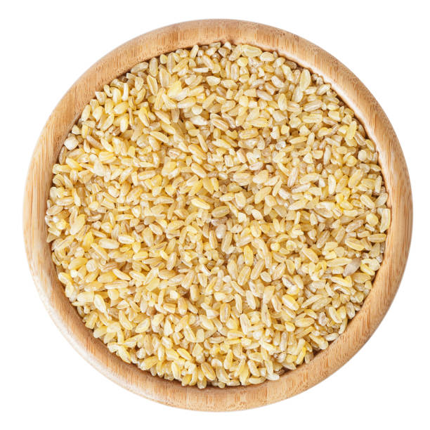 istock Uncooked bulgur in wooden bowl isolated on white background with clipping path 1090400502