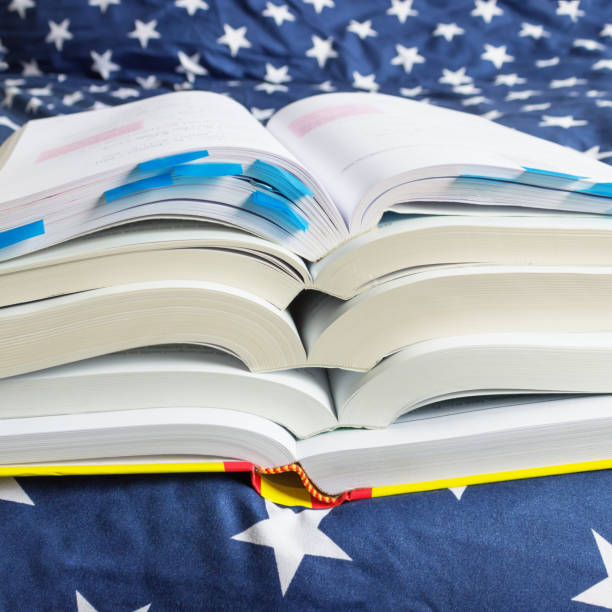 istock A stack of books with bookmarks lie on a blue blanket. Concept- exam preparation, session, school, education, study hard. Selective focus. 1090402686