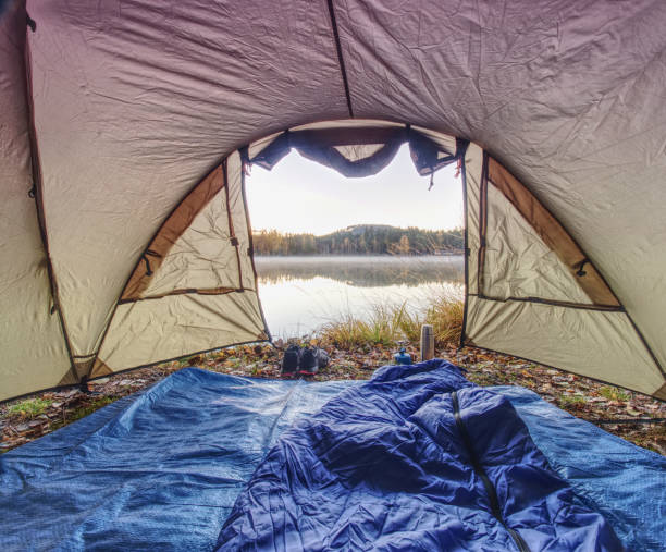 istock Tent on romantic place at lake. Colorful fall forest 1090403620