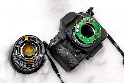 When You are slipping, cameras can broken. Broken dropped wide angle camera lens and lens on the snow when snowing