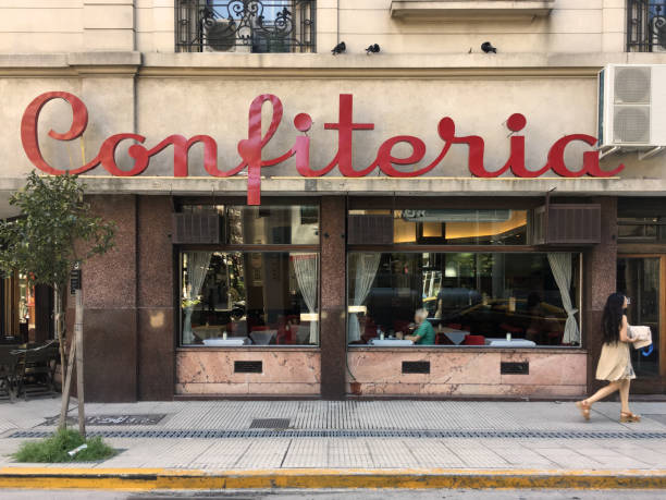 Confiteria Buenos Aires, Argentina - January 5, 2019: Sidewalk cafe in street corner with huge window and people having coffee inside. The city has a huge cafe culture city street street corner tree stock pictures, royalty-free photos & images