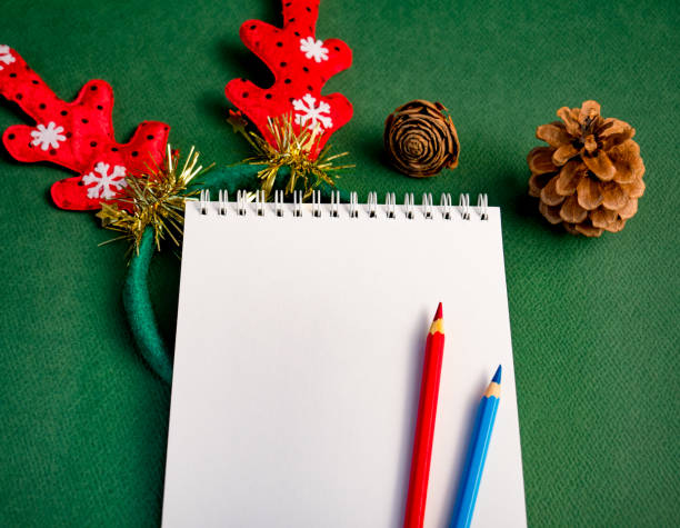 istock Workplace for Christmas concept. Blank notebook and colored pencils for your text 1090416944