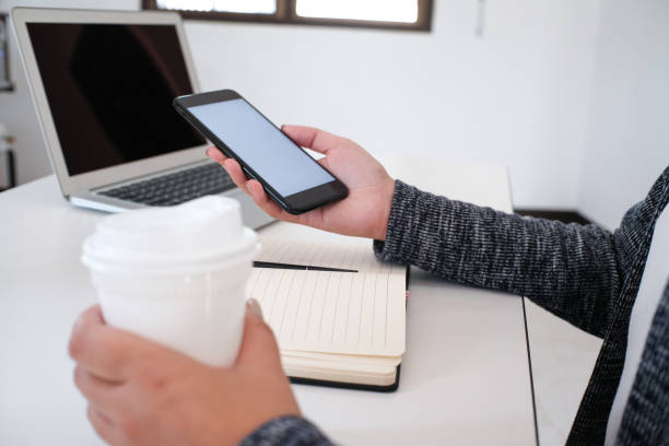 istock girl using smart phone in office. hand holding smart phone white screen 1090419224