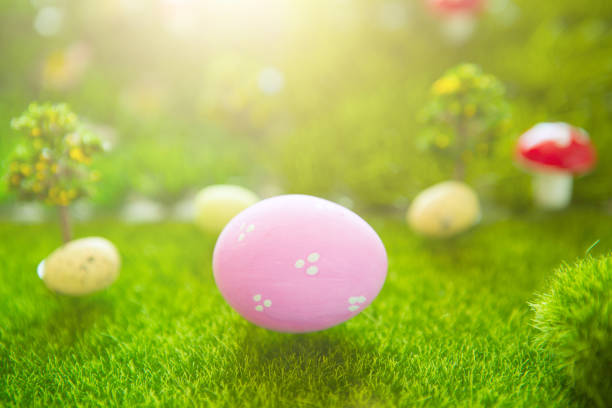 istock Easter background with pink Easter eggs on green grass in pastel colors in spring of Dreamland or fairy world 1090419430