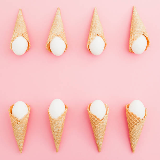 istock Easter eggs in waffle cones on pastel pink background. Top view, Flat lay. Easter frame concept. 1090421084