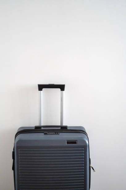 istock gray plastic hard suitcase with retractable telescopic handle. One suitcase prepared for a business trip. 1090422802